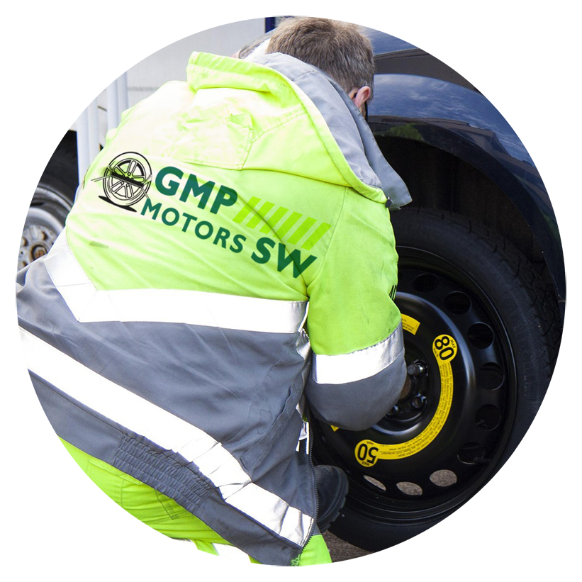 Services - GMP Motors SW - 1 of our team wearing a high visibility jacket changing a flat tyre